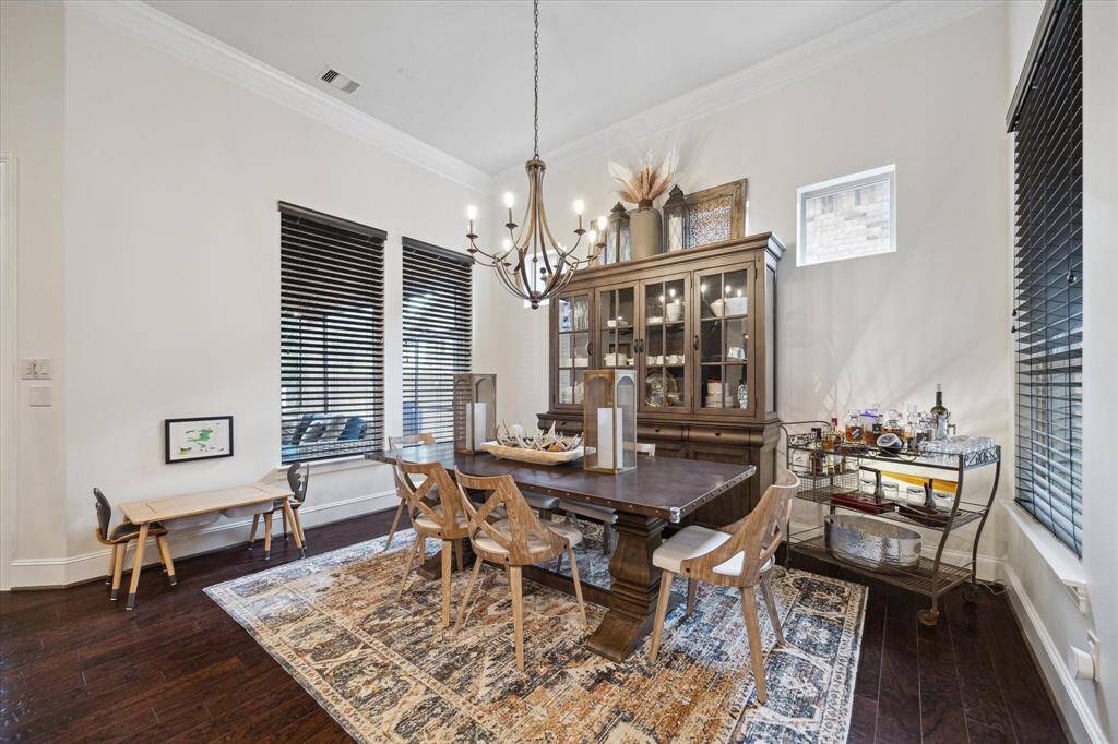 Large Dining Room with crown molding and lots of natural light.