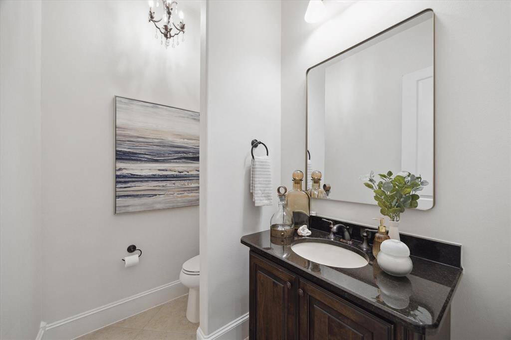 Powder Bath with furniture-style vanity and custom framed mirror.