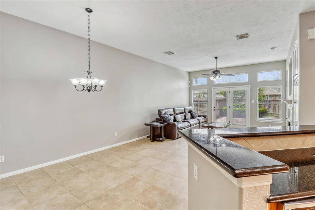Just off the kitchen, the cozy breakfast area features a charming hanging light fixture overhead, creating a warm and inviting space.