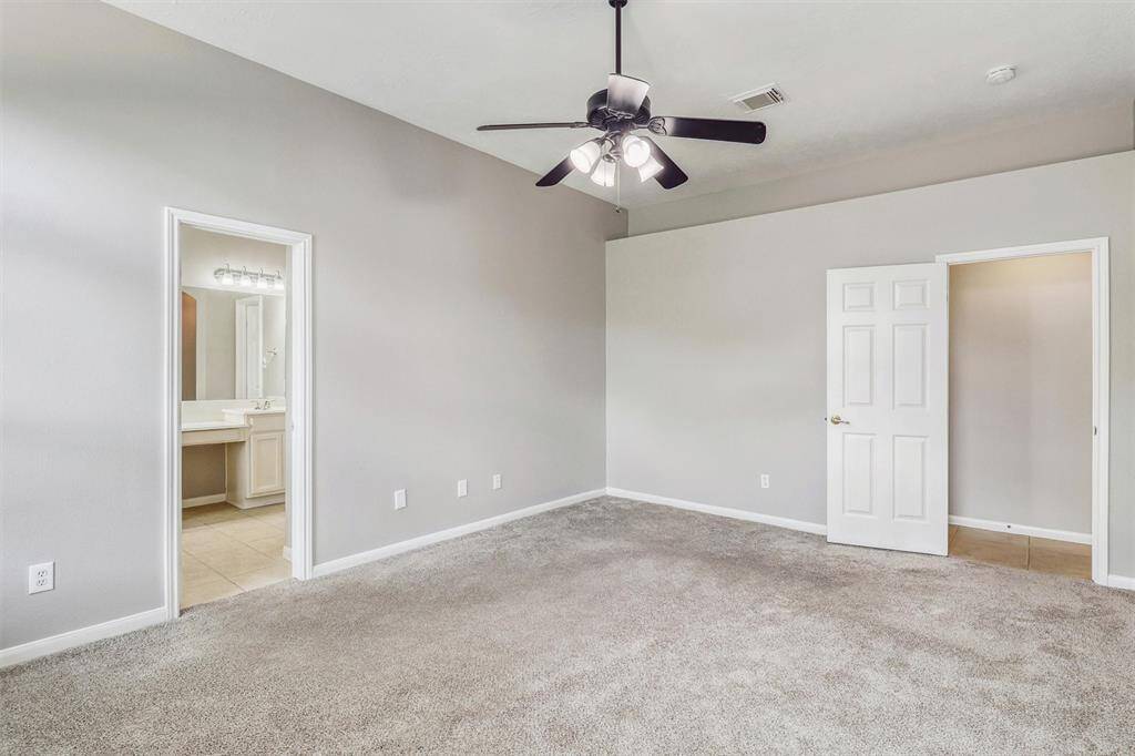 Notice the unique cutout along the length of the wall near the ceiling, adding architectural dimension and interest. From here, continue on to your private ensuite bathroom!