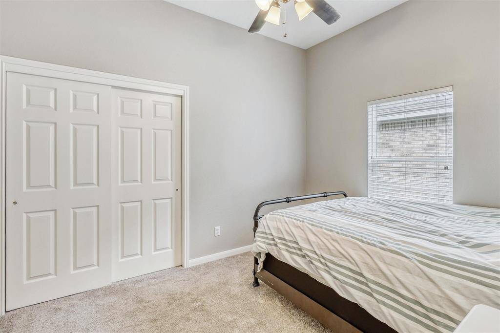 This room also features a large reach-in closet with a sliding door, along with a sizable window that fills the space with abundant natural light.