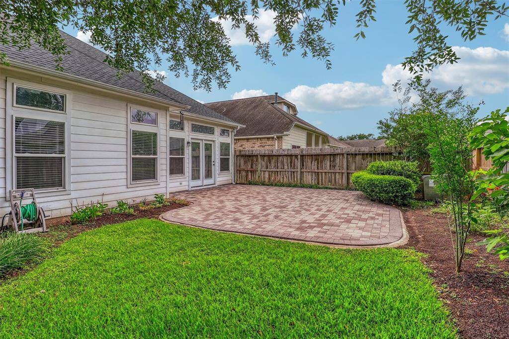 In addition to the expansive patio, there's also plenty of green space for pets or children to roam and play freely.