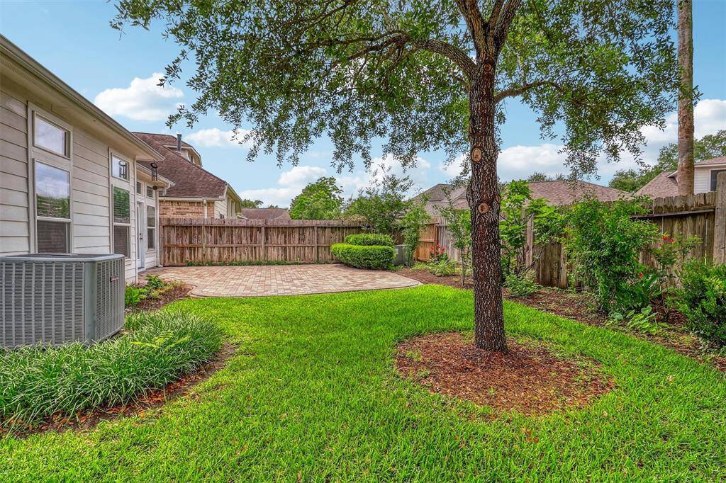 This backyard offers the perfect balance of relaxation and play, featuring a spacious patio for outdoor entertaining and ample greenspace for pets, children, or simply enjoying nature.