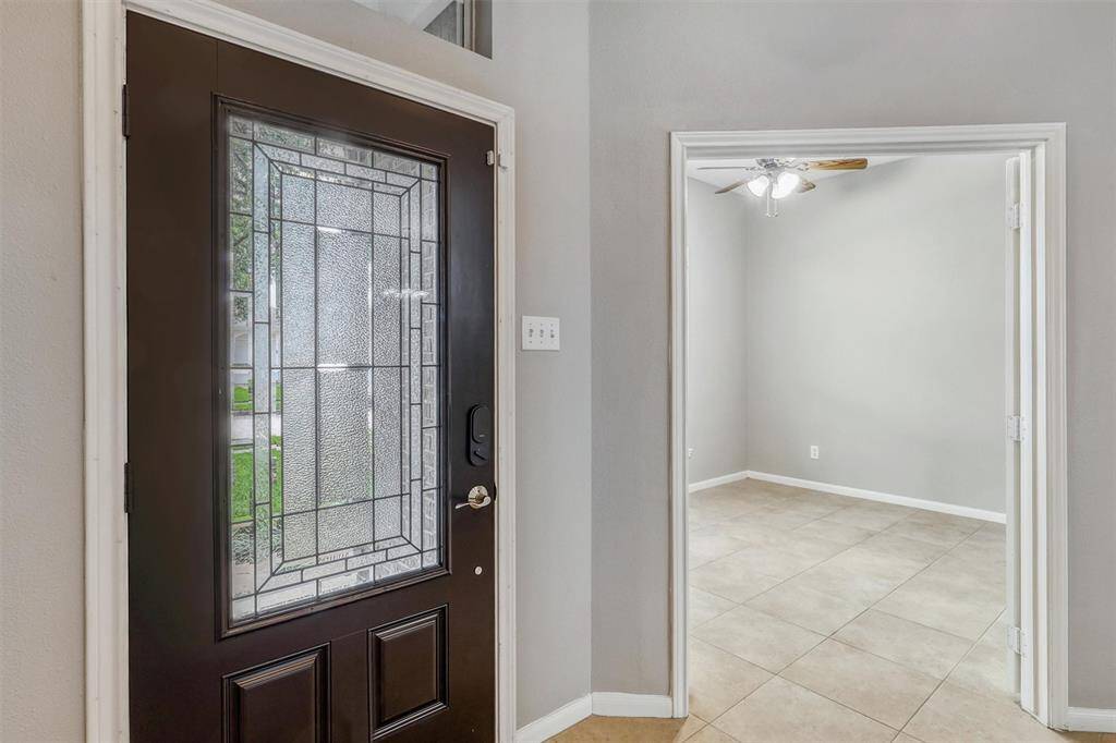 Take a closer look at the stunning glass detail on the front door. Just off the entryway, you'll find a private study offering an elegant and quiet retreat.