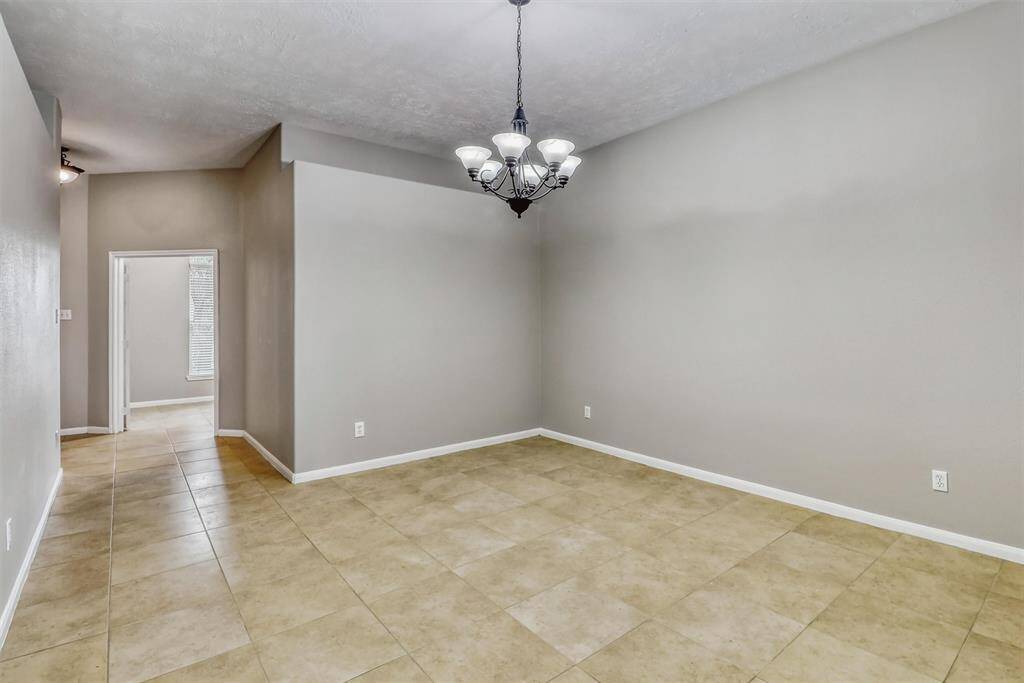 Continuing from the entryway, you'll find a spacious dining area featuring tile flooring and stylish decorator paint—perfect for hosting gatherings or everyday meals.