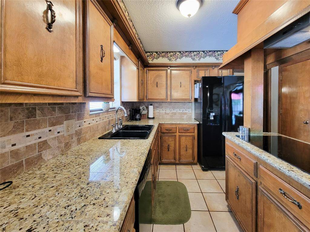 Granite tiled countertops with travertine backsplash