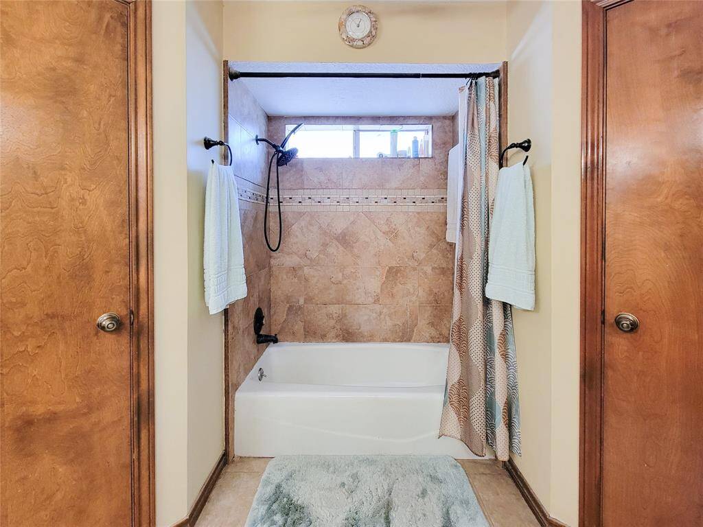 Tiled shower and 2 closets