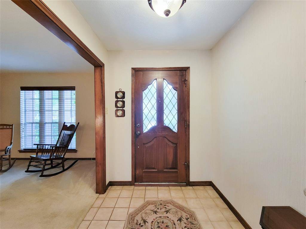 The entryway features a wooden door with decorative glass panes.