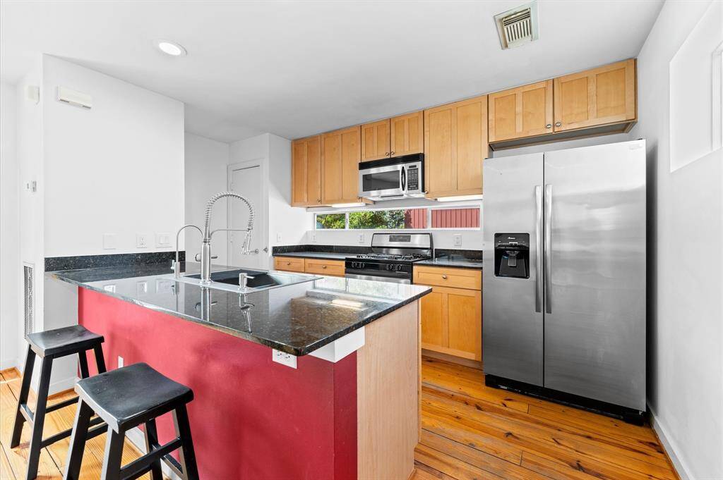 Modern kitchen with stainless steel appliances.