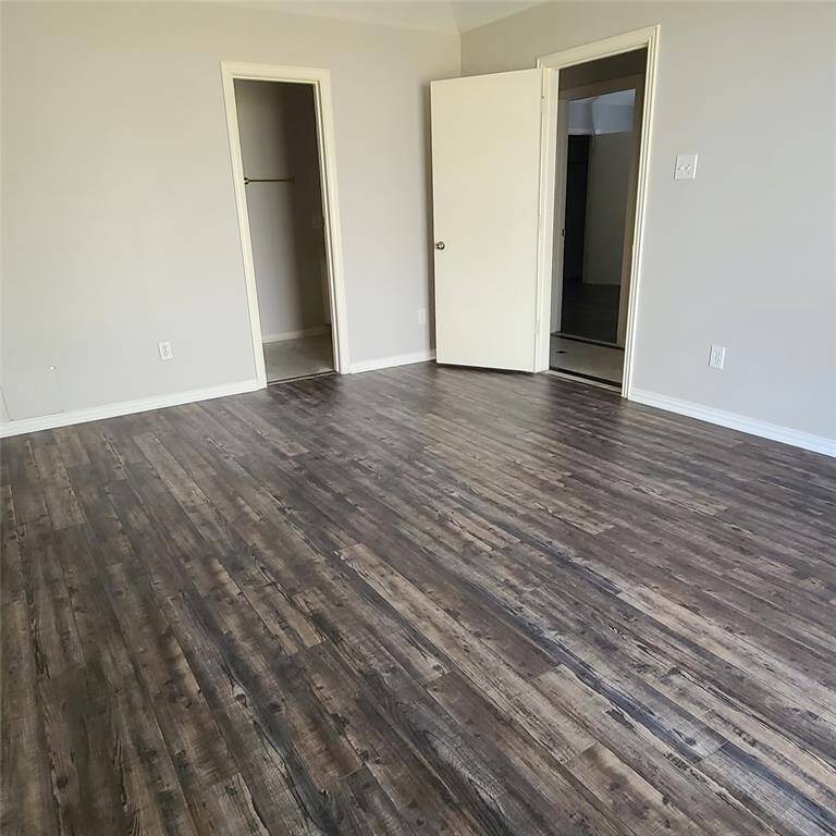 A large primary bedroom overlooks the back yard