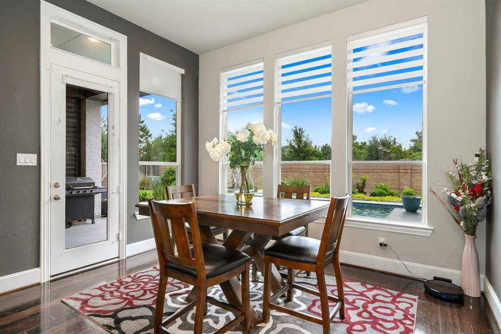 Enjoy a cup of coffee while enjoying the view of the pool and the beautiful landscaping from this breakfast nook.