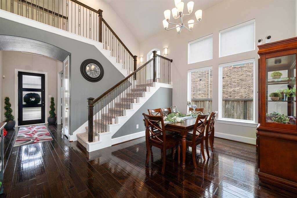 The formal dining room is quite spacious and can fit a large table for special dinner events. High ceilings with a chandelier and large fixed windows make a statement in this room.