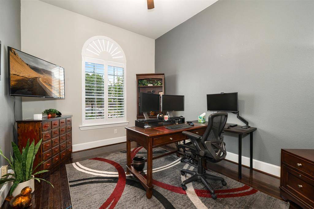 This spacious home office is on the first floor. Plantation shutters control privacy as this room faces the front of the home. This room can be converted to a 5th bedroom if needed (access to a closet and full bath).