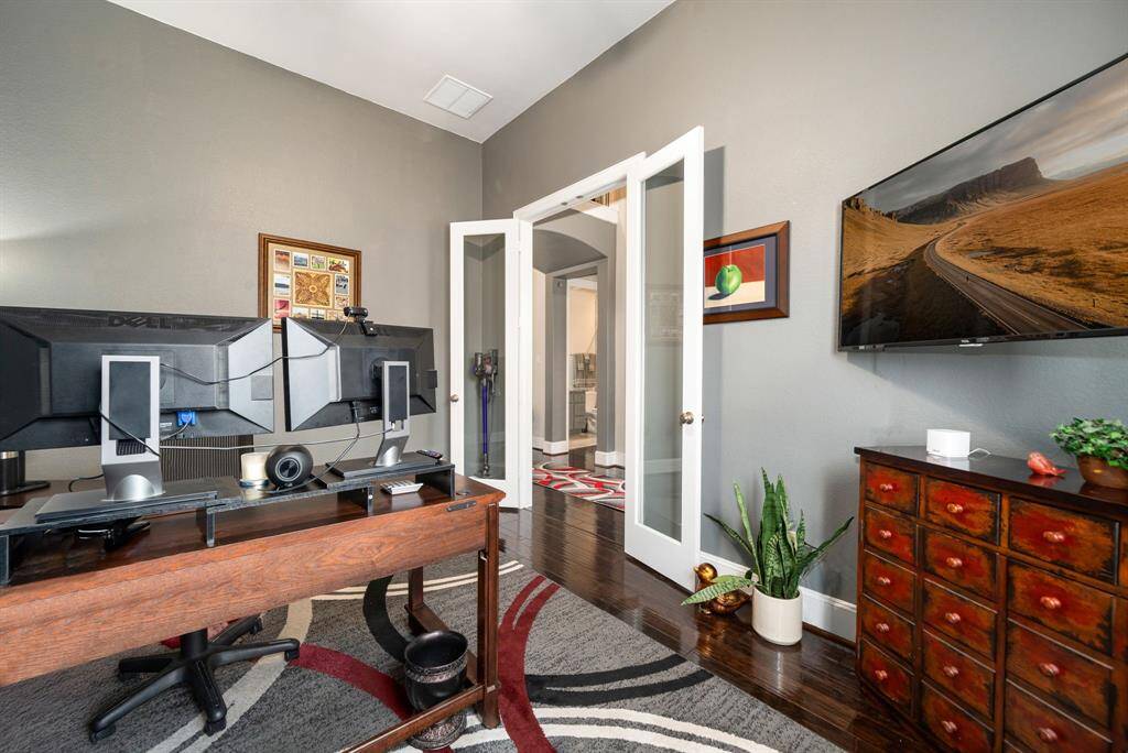 Another view of the home office looking out to the foyer. Double glass entry doors allow more natural light, which helps boost mood and productivity.