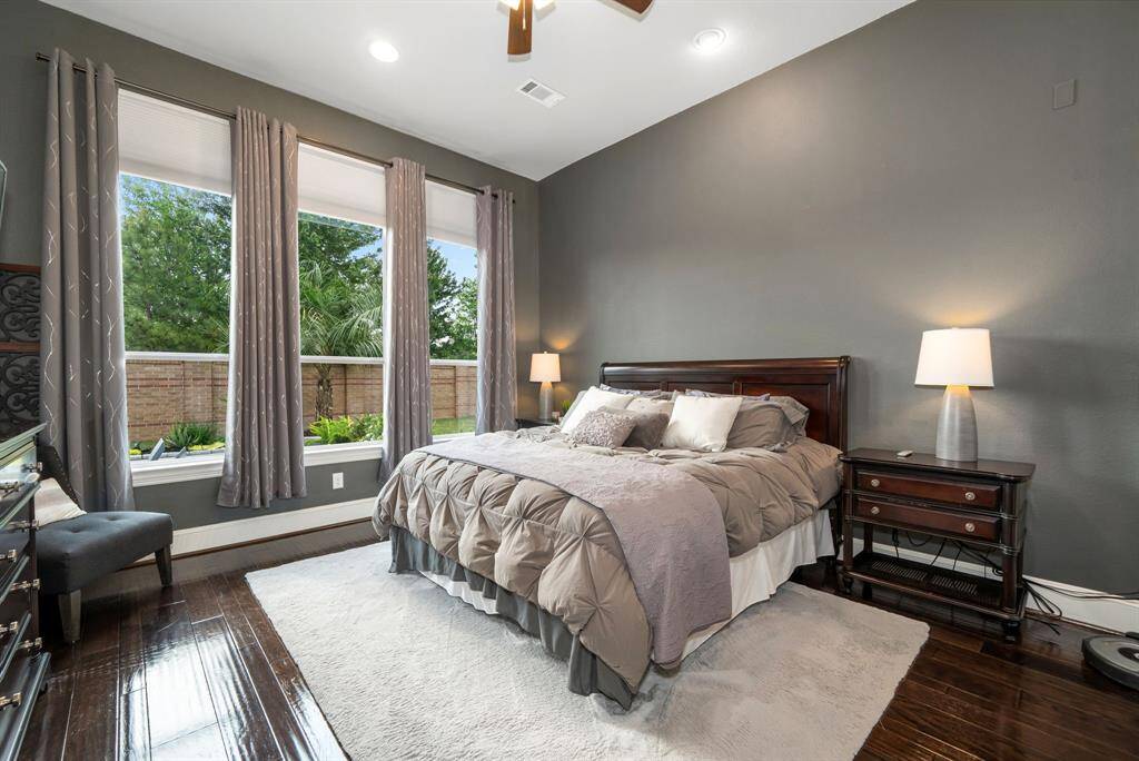 The primary bedroom retreat is tucked away in the back of the home. Wake up to a great view of your lovely backyard. High ceilings, no carpet! Ceiling fan and LED lighting. Soothing designer paint colors make this room feel really Zen.