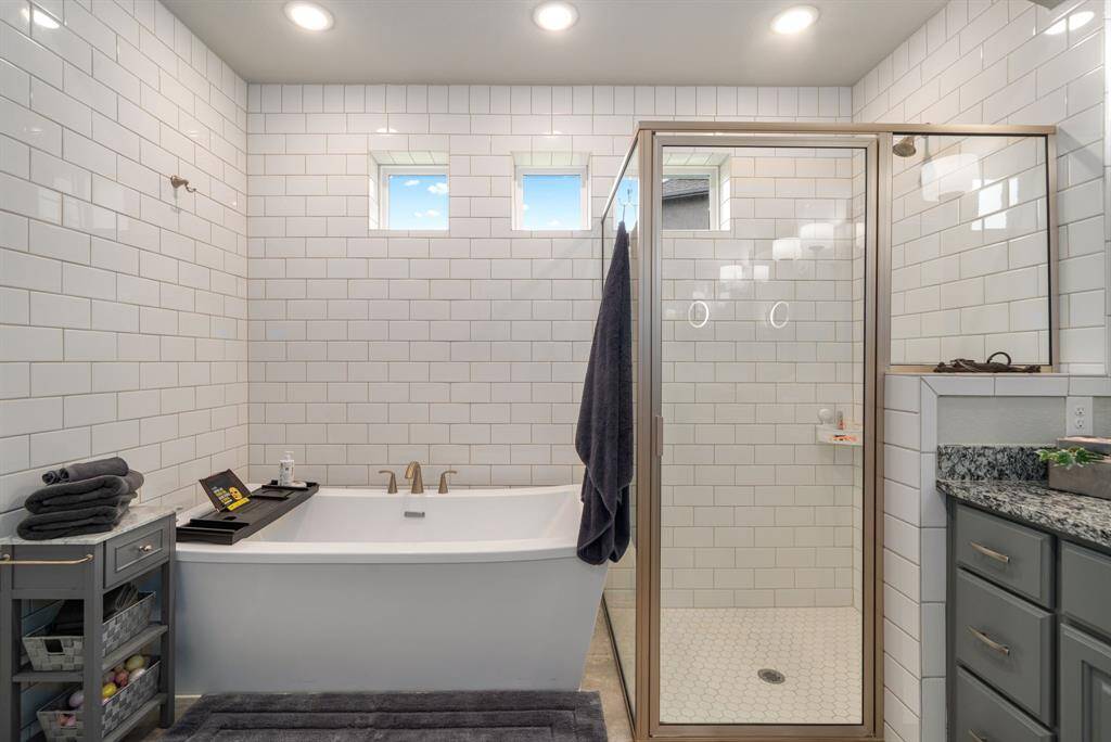 Take the stress off in the evenings in this stand-up shower or soak in this oversized relaxing bath.