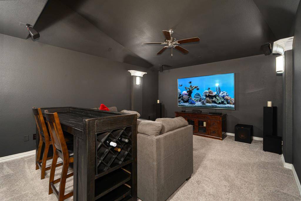 Dedicated movie theater on the 1/2 floor upstairs for fun family nights. This entertainment space has access to its own powder bath on this floor. Grab the popcorn and turn up the sound. Great room for catching your best sports games.