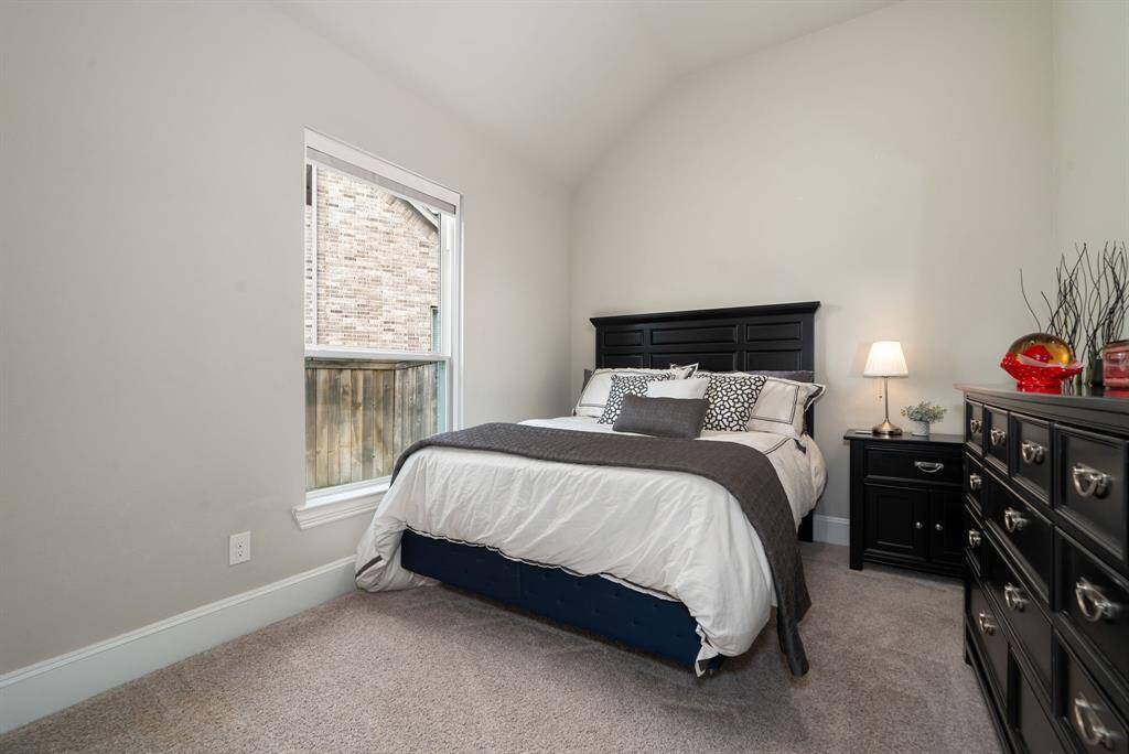 Secondary bedroom with high ceilings is conveniently located with full bathroom access.