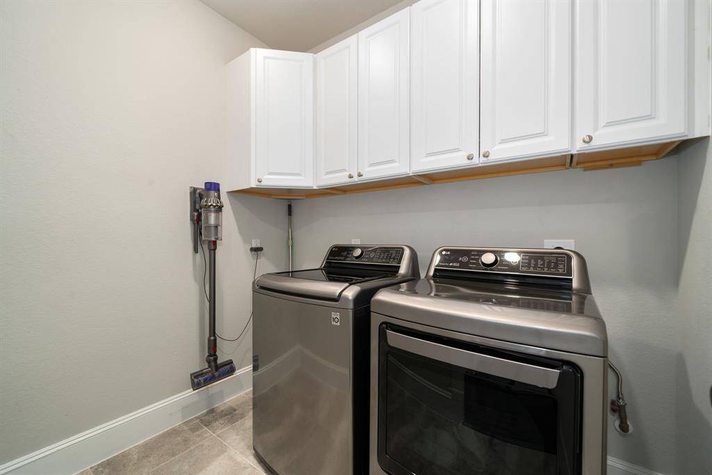Laundry room with overhead storage for bulk items or laundry supplies.
