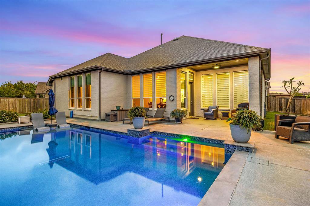 Rear elevation. LED color-changing pool lights offer custom lighting variations to set the mood at sunset. The pool is heated, which is quite convenient for use in cooler temperatures.