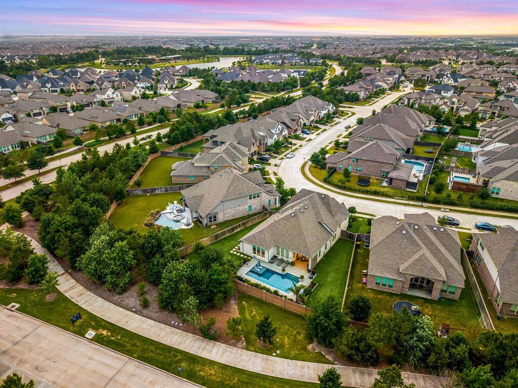 Rear aerial view of 16110 East Moss Loop, Cypress TX 77433, walking path backs the home.