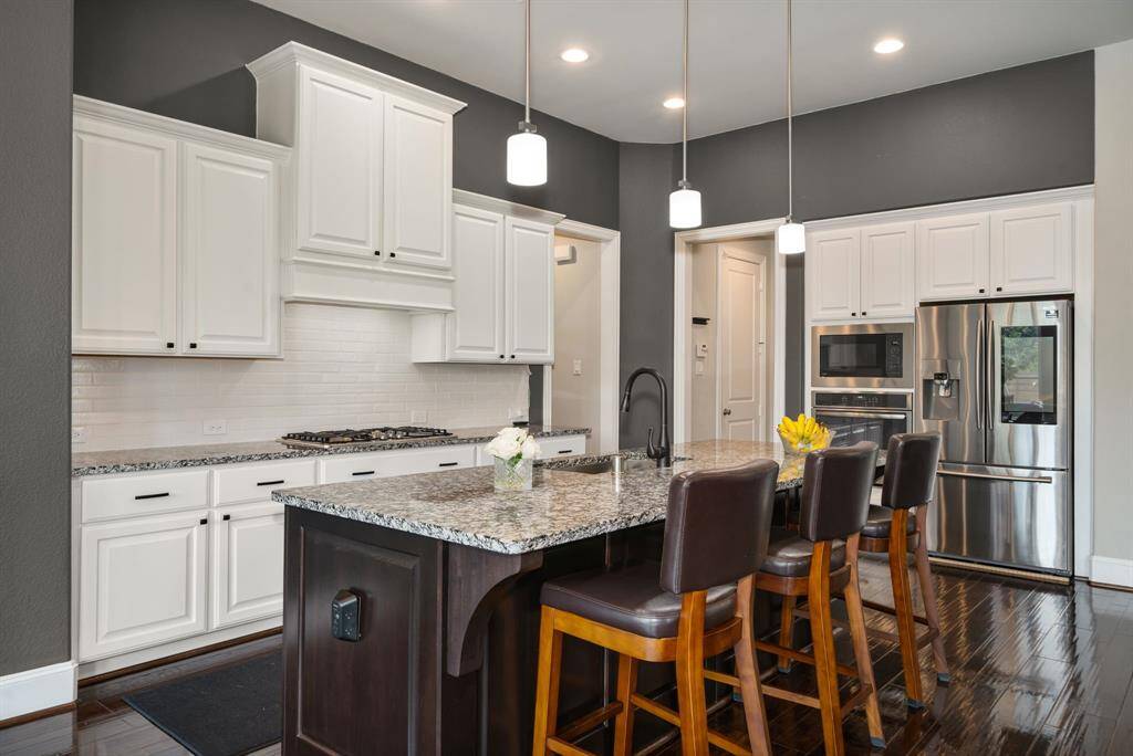 Another view of the kitchen with a large island and bar-height seating for easy entertaining.