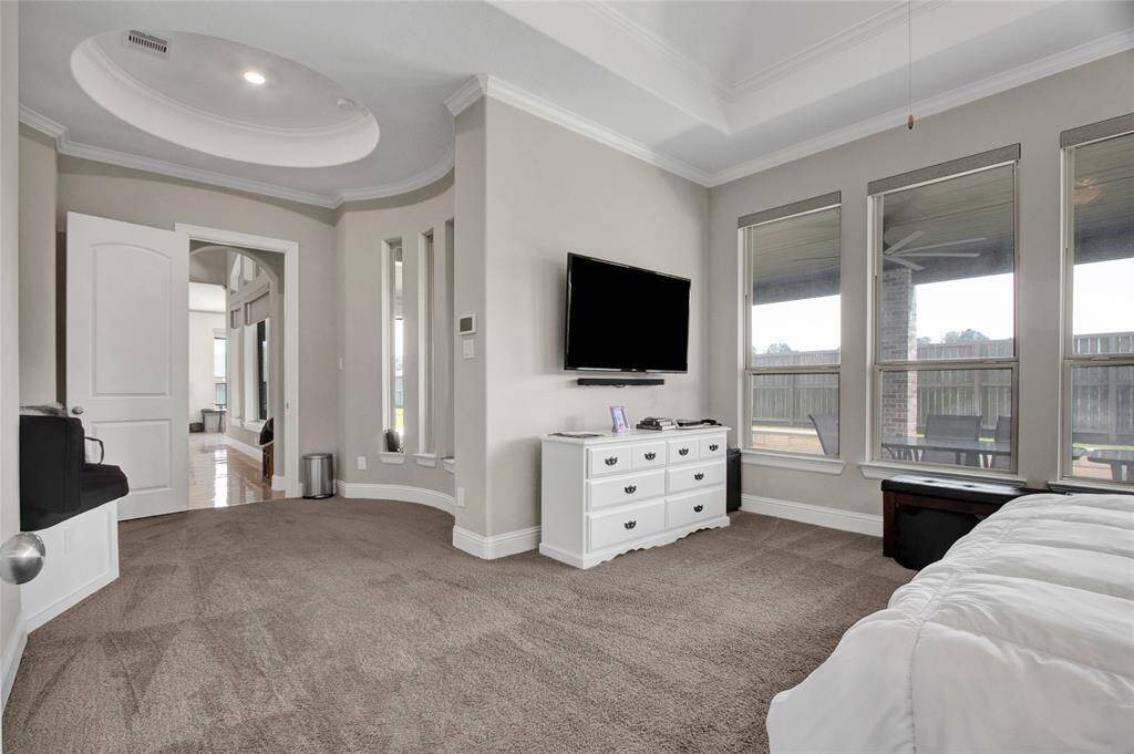 Plush carpeting and neutral tones create a serene retreat, perfect for relaxation.