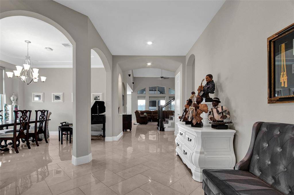 Experience timeless elegance in the grand foyer, offering a preview of the luxurious lifestyle this home offers.
