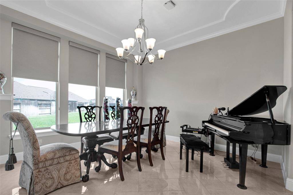 Host unforgettable gatherings in this beautifully appointed formal dining room, where classic charm meets abundant natural light.