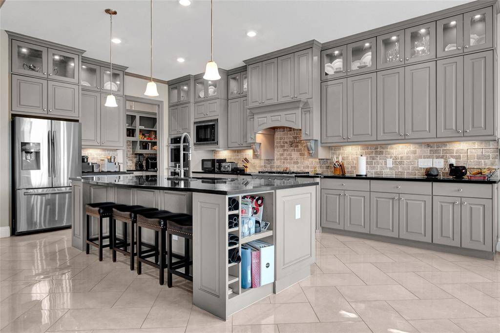 Experience the perfect blend of elegance and practicality in this gourmet kitchen.
