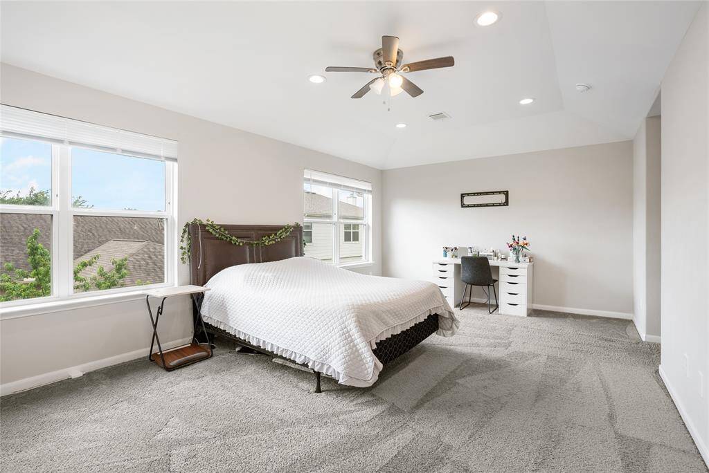 This INCREDIBLY spacious primary bedroom is perched on the second floor with large windows that invite natural light throughout the space!
