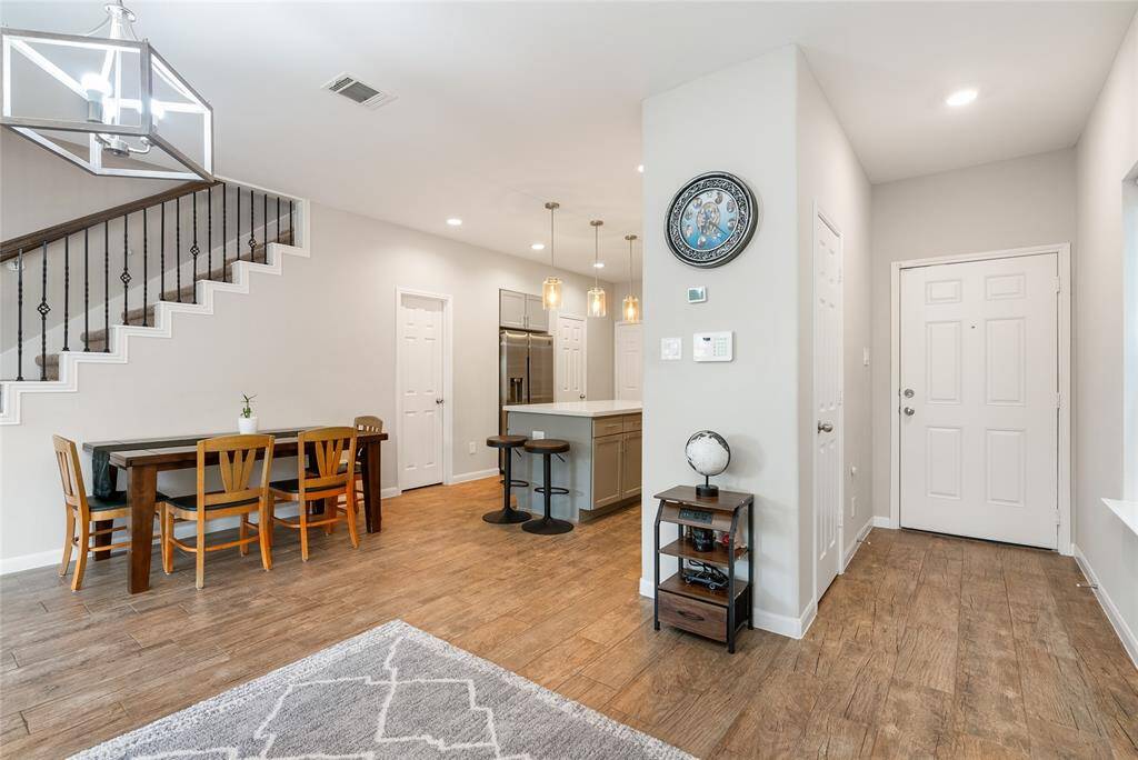 As soon as your guests enter, they will be wowed by open and airy feel of this space! Bright chandeliers and charming pendant lighting provide sophisticated touches to this living area.