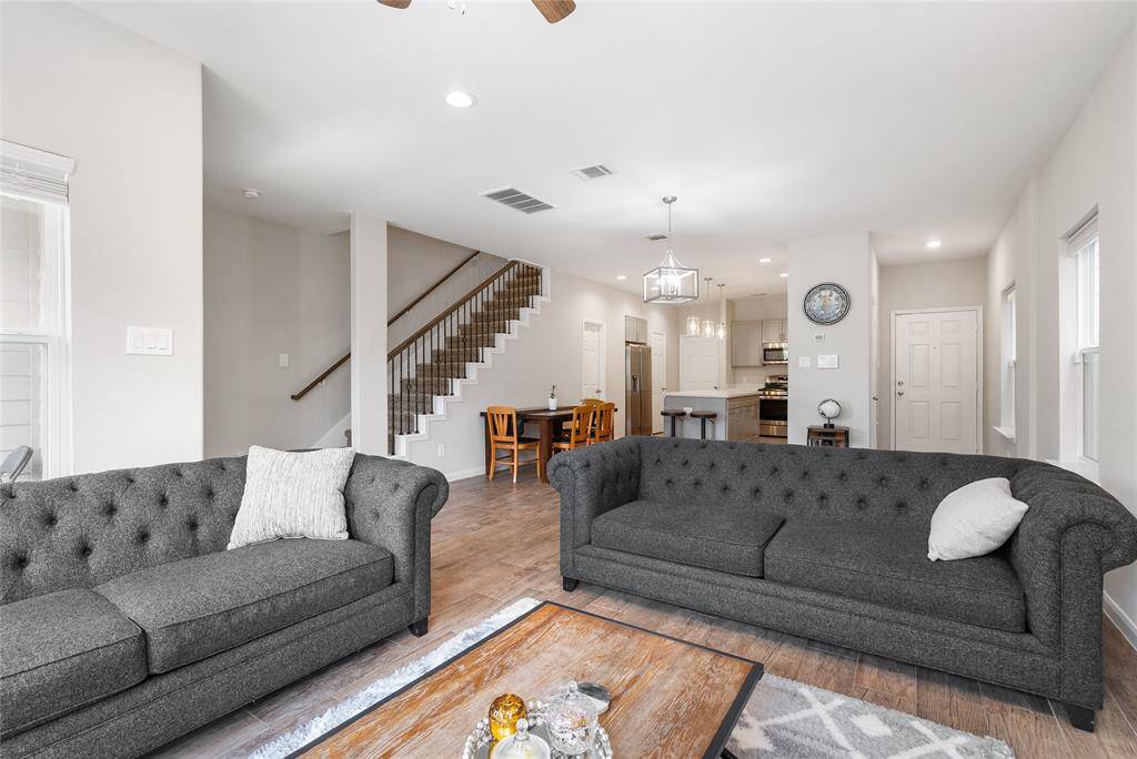 Make memories with friends and family as everyone gathers around the living room. Neutral painted walls, rod-iron stairs and elegant wood-look flooring are awaiting your personal touches!