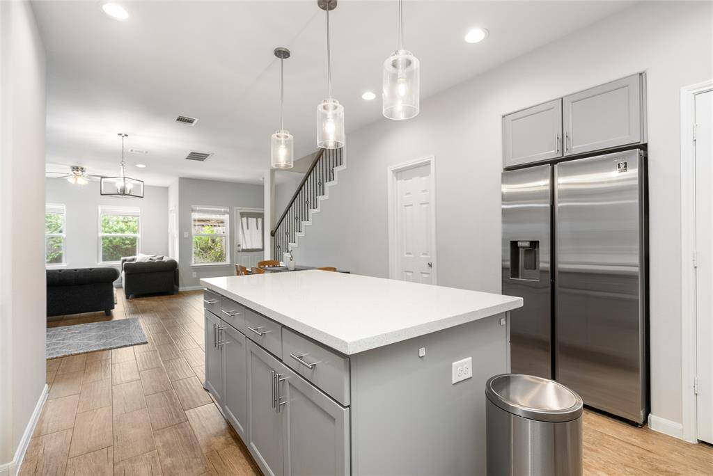 At the end of the night, friends and loved ones will gather around this ENOURMOUS kitchen island, equipped with storage space!