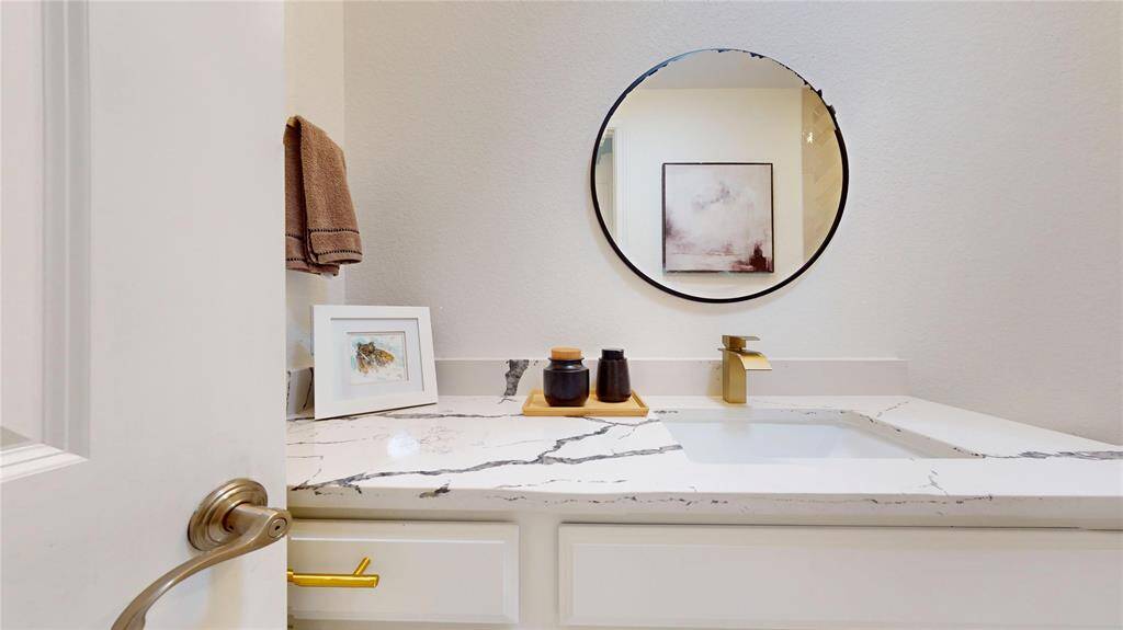 Herringbone tile and wall in tub with handheld shower