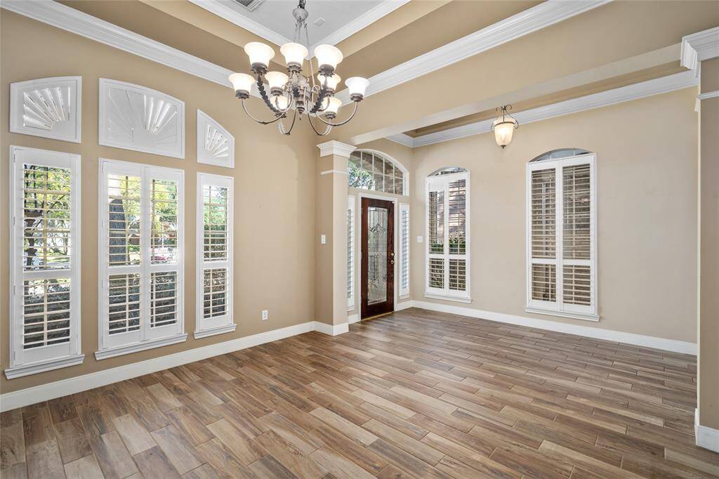 The wall of windows in this room offers a clear view of your beautifully maintained front yard, bringing the outdoors in and filling the space with natural light. It’s the perfect spot to relax while enjoying the serene view of your front yard.