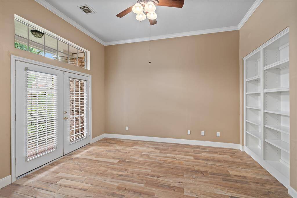 This versatile room can easily serve as a home office, complete with built-in cabinets for ample storage, elegant French doors for added privacy, and a convenient walkout that leads directly to the front lawn. Whether you're working from home or in need of a quiet retreat, this space combines functionality with charm.