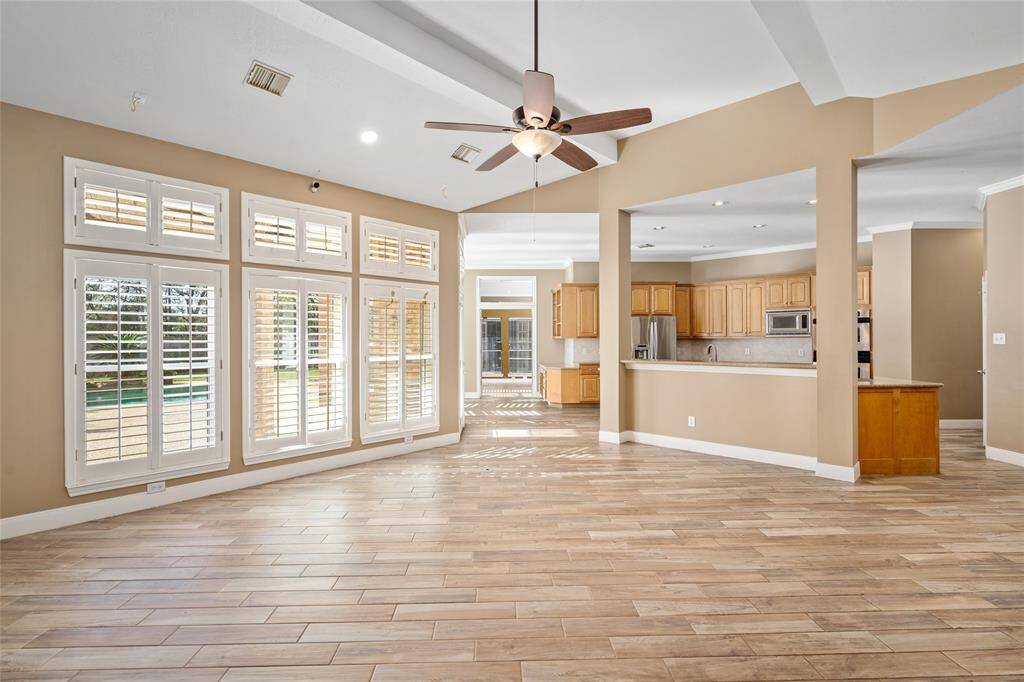 The living room flows seamlessly into the kitchen, creating an open and inviting space that’s perfect for entertaining or family time. This open layout allows for easy interaction between rooms, making it ideal for both everyday living and hosting guests.