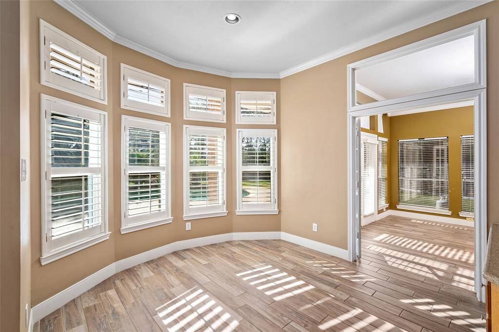 The cozy breakfast room offers a lovely view of the backyard and pool, making it the perfect spot to enjoy your morning coffee. With abundant natural light streaming in, you can soak in the warmth of the outdoors while starting your day in this serene, inviting space. ***The Sunroom was repainted to the neutral paint color***