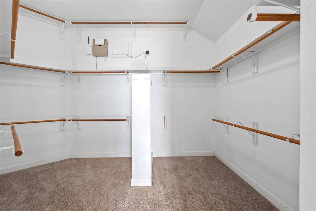 The spacious walk-in closet provides ample storage and organization, with plenty of room to keep your wardrobe neatly arranged. Its generous size and thoughtful design make it a practical yet luxurious feature of the primary suite.