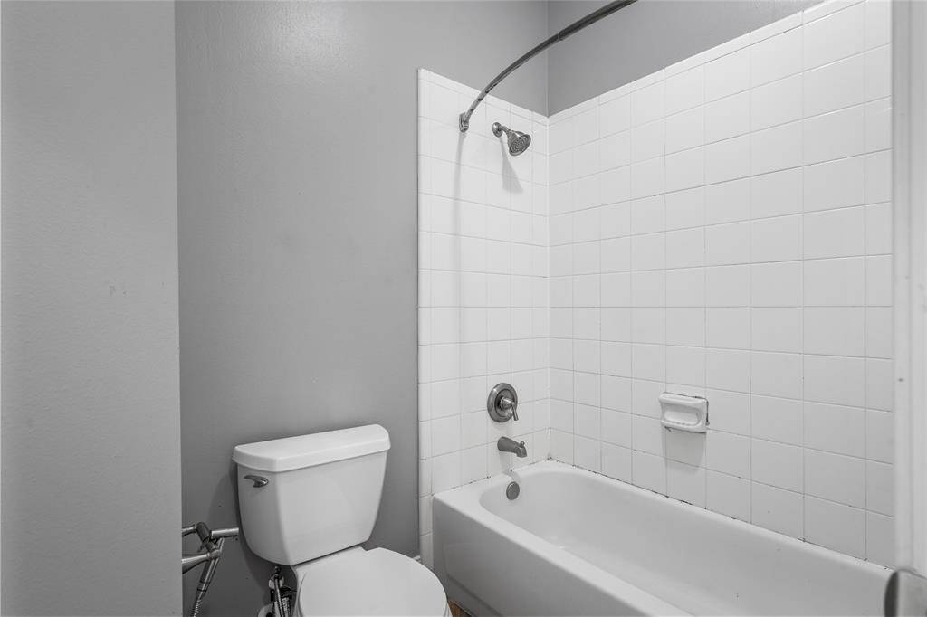 The secondary bathroom is equipped with a tub and shower combo, offering both convenience and versatility. Whether you’re looking to relax in the tub or enjoy a quick shower, this functional space caters to your needs with ease.