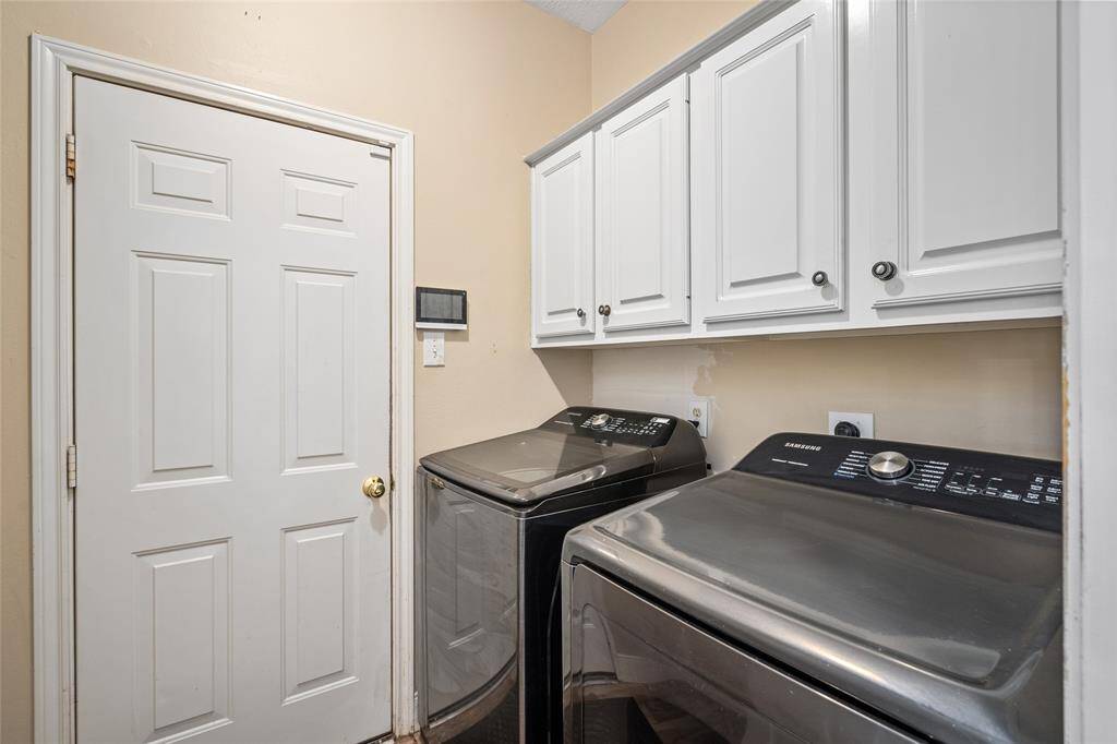 The conveniently located utility room is perfect for laundry and additional storage. It offers easy access and plenty of space for both the washer and dryer, as well as room for organizing cleaning supplies, making chores more efficient and organized.