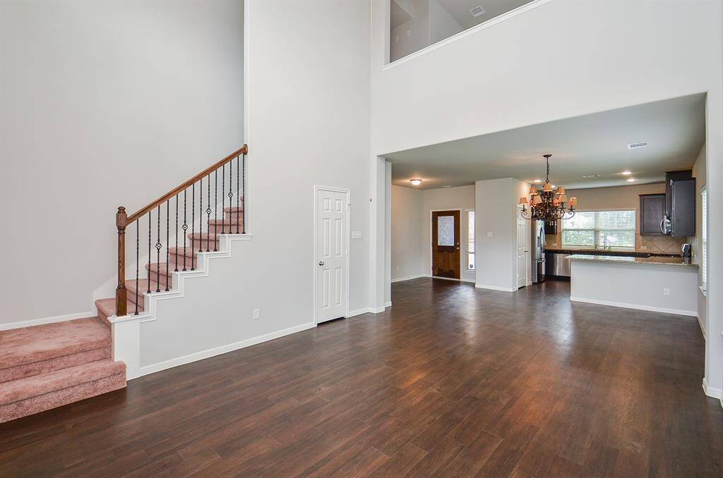Walls of windows embrace the placement of the carpeted staircase and light this majestic space.
