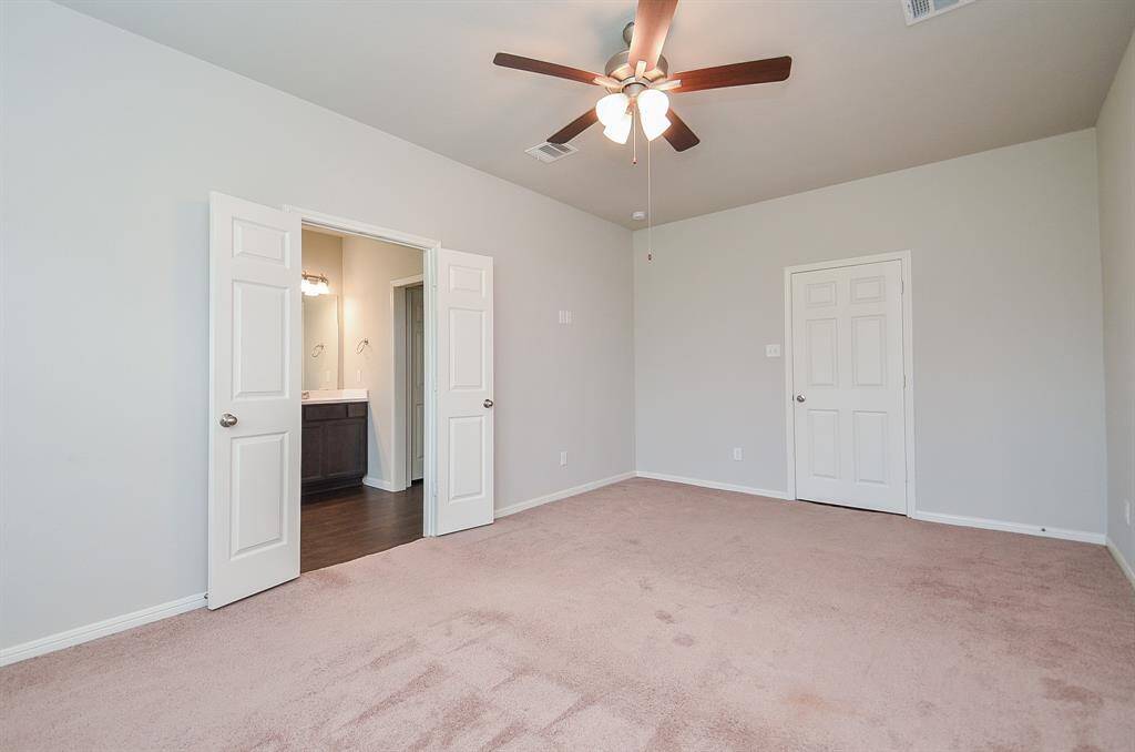 The appealing dark/light theme continues in the primary ensuite bath, with dual sinks, tons of storage below; a wall-wide mirror and delicate lighting above.. The walk-in shower and garden tub sit side-by-side.