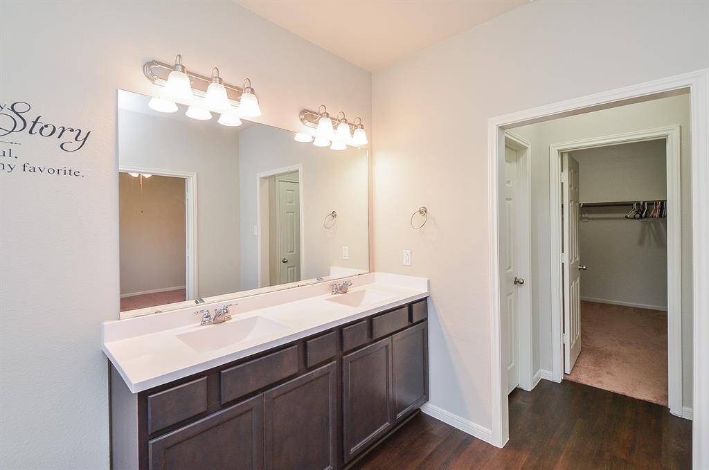 Wow! Built in shelving, tons of hanging rods and cushy carpeting fill the primary walk in closet, with what looks like a utility space (laundry appliances), right.