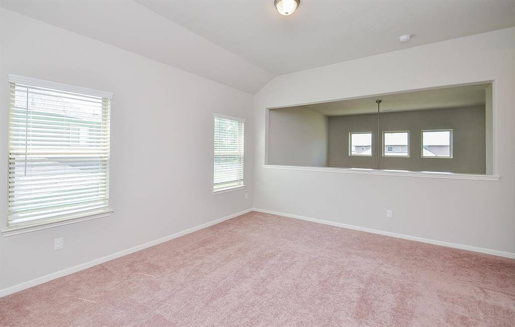 A spacious secondary carpeted bedroom enjoys its own ensuite bath.