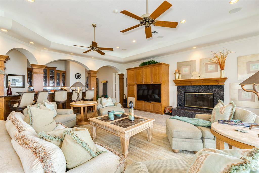 The living room features 1 of 4 wood burning fireplaces in the home.