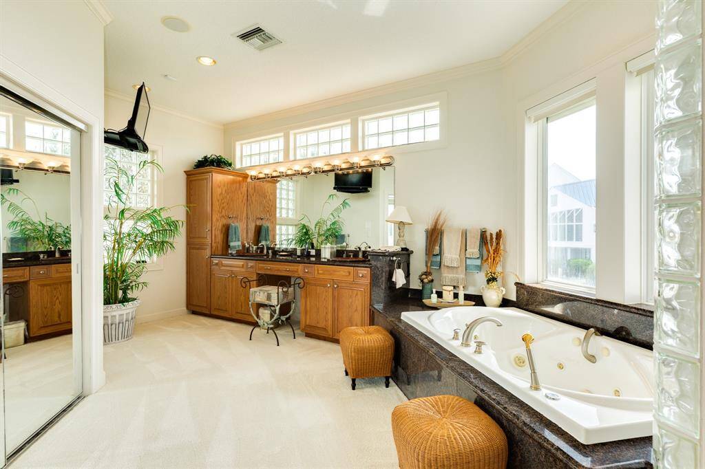 The primary bath includes a jetted tub, water closet with bidet, multi head walkin shower, large walkin closet plus a linen closet. Wonderful natural light abounds via the transom glass block windows.