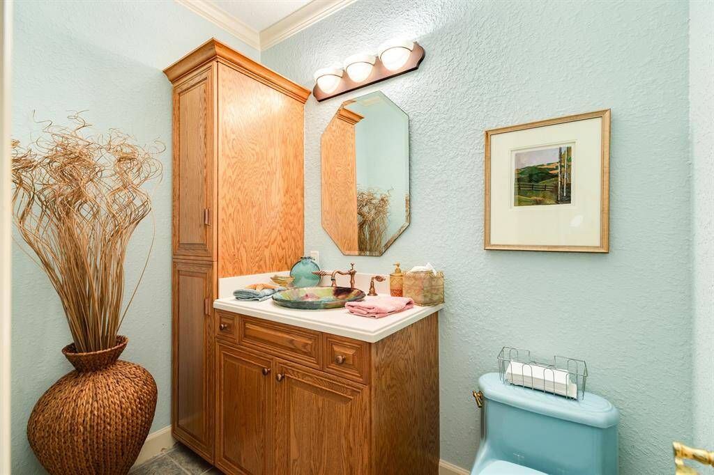 The main level of the home also includes a powder room just off the main hall & outside of the utility/pantry room.