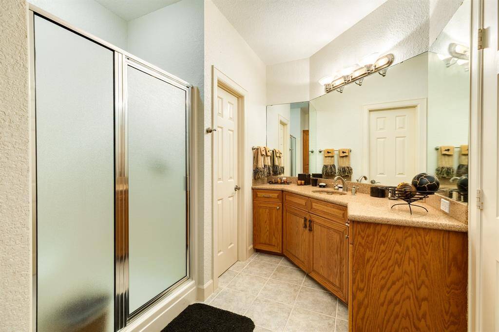 There are three bathrooms on the second level of the home. This bathroom has can be accessed from the family room and office though separate doorways.